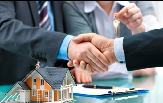 A group of people shaking hands over a table.